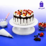 حامل كيك دوار أبيض محمل بتورتة فاخرة مع أدوات التزيين